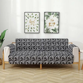 Housse de canapé matelassée une pièce avec motif feuilles et sangles élastiques antidérapantes