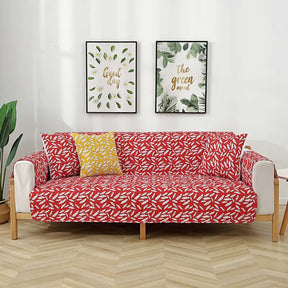 Housse de canapé matelassée une pièce avec motif feuilles et sangles élastiques antidérapantes