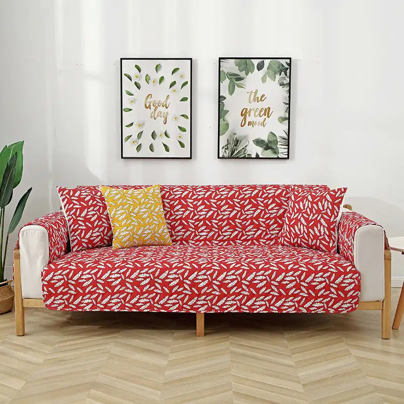 Housse de canapé matelassée une pièce avec motif feuilles et sangles élastiques antidérapantes