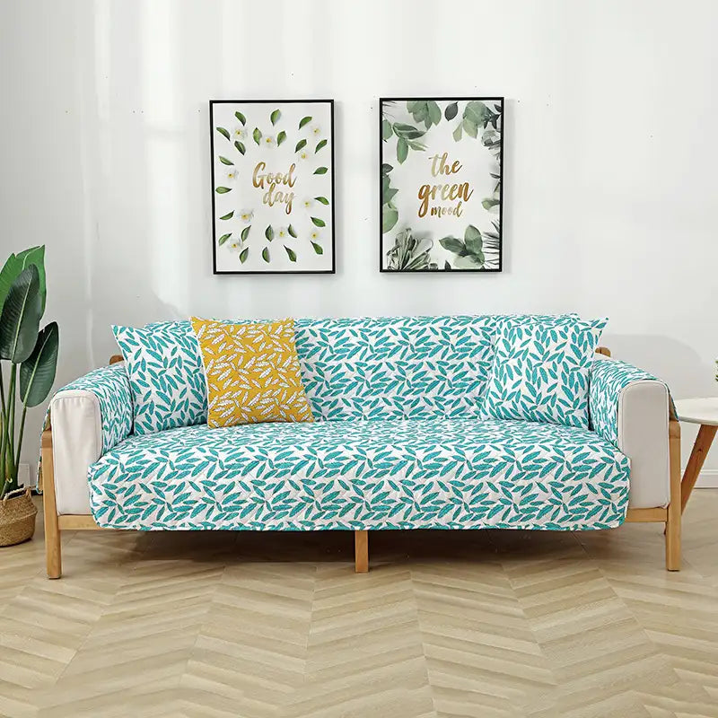 Housse de canapé matelassée une pièce avec motif feuilles et sangles élastiques antidérapantes