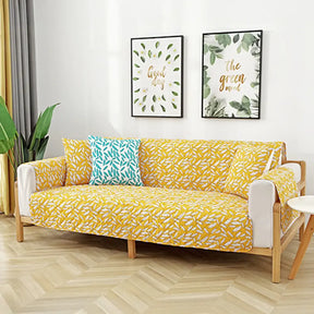 Housse de canapé matelassée une pièce avec motif feuilles et sangles élastiques antidérapantes