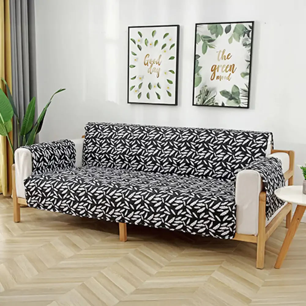 Housse de canapé matelassée une pièce avec motif feuilles et sangles élastiques antidérapantes